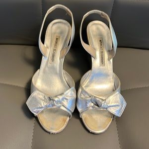 Manolo Blahnik silver wedge bow sandals.